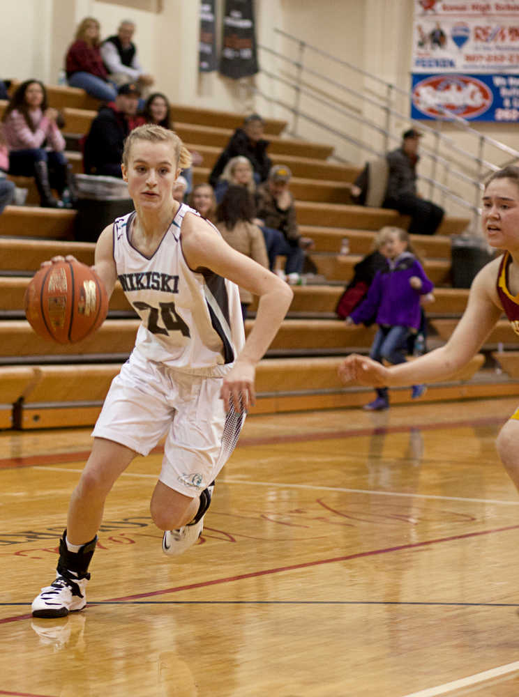 Photo by Rashah McChesney/Peninsula Clarion  Nikiski Bulldog Rachel Thompson runs in for a layup during their game against the Mt. Edgecumb Lady Braves Friday Dec. 20, 2013 at Kenai Centra High School in Kenai, Alaska.