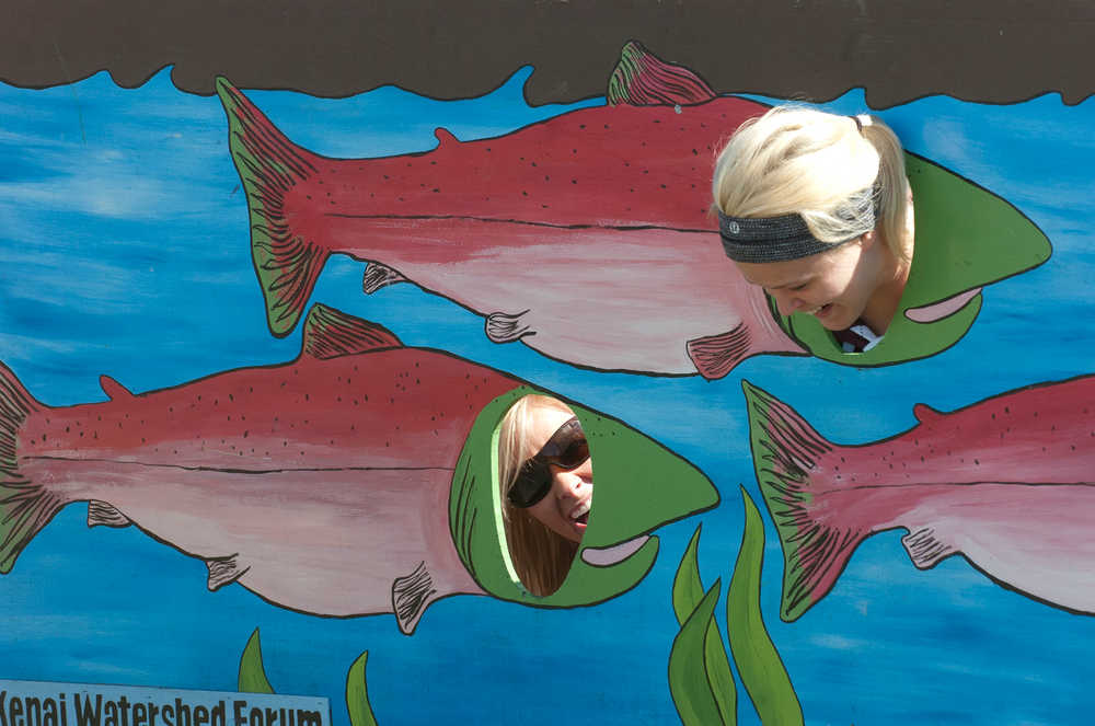 Photo by Rashah McChesney/Peninsula Clarion   (left) Megan Kramer and Lauren Bauder laugh while posing as king salmon during the Kenai Watershed Forum's 23rd Annual Kenai River Festival Saturday June 8, 2013 in Soldotna, Alaska.