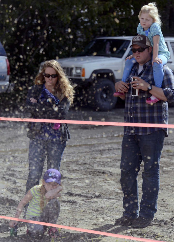 Photo by Rashah McChesney/Peninsula Clarion (left) Hailey, Sondra, Roy and Taylor Stonecipher watch as Carmen West, of Hatcher Pass, works on a chainsaw carving during the Soldotna Progress Days festival Saturday July 26, 2014 at the Soldotna Little League fields.