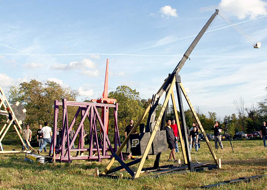 The Lords of the Chunk, a team from Purdue University College of Technology, send a pumpkin down the firing line at the Harvest Homecoming Pumpkin Chunk on Tuesday, Oct. 7, 2014 in New Albany, Ind. Six teams built trebuchets for the first-ever event.  (AP Photo/News and Tribune, Staff, Jerod Clapp)