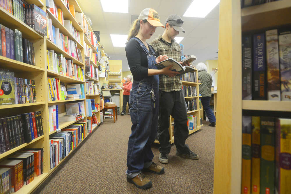 Photo by Kelly Sullivan/ Peninsula Clarion Kyle Hilleary and Amber Smith took time in their off day to peruse the shelves at River City Books Wednesday, Nov. 19, 2014, in Soldotna, Alaska. Smith said they were looking for some rest and relaxation.