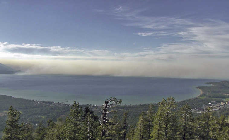 This undated photo provided by the University of Nevada Reno, shows smoke from the King Fire in a view north across Lake Tahoe in South Lake Tahoe, Calif. University researchers are helping federal forest and range managers expand the use of cameras to spot wildfires at Lake Tahoe to the tops of mountains in remote parts of northeast and central Nevada, including one north of Battle Mountain that gave an early warning of a fire more than 100 miles away in Oregon. (University of Nevada Reno via AP)