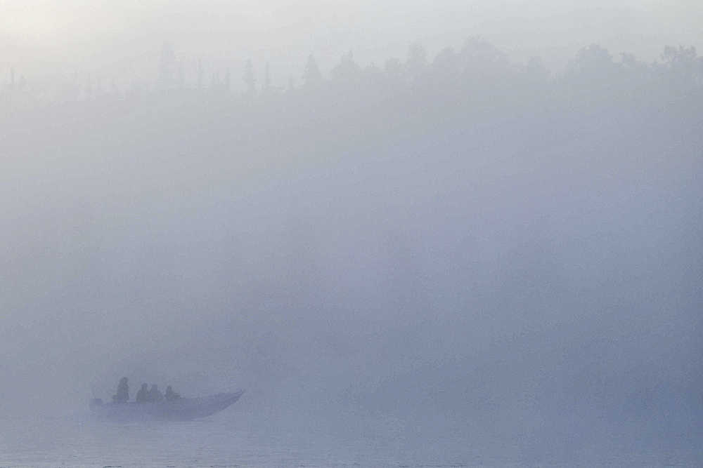 Photo by Rashah McChesney/Peninsula Clarion  A boat is enveloped by fog as it makes its way slowly up the Kenai River on Monday August 24, 2015 near Kenai, Alaska. Silver fishing has drawn crowds of anglers to the river since mid-August and will likely continue to do so through mid-September, though the river presents good silver fishing opportunity through late fall.