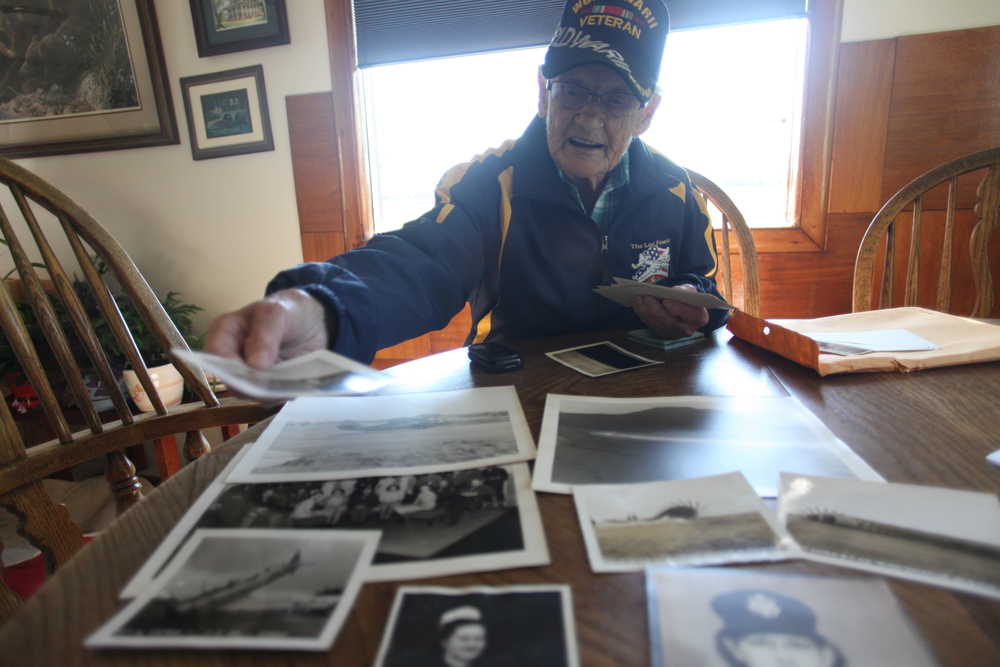 Photo by Kelly Sullivan/ Peninsula Clarion Kathleen Mize pulls out photographs from when she served as a nurse in Alaska and Calif. during World War II on Wednesday, June 8, 2016, in Sterling, Alaska.