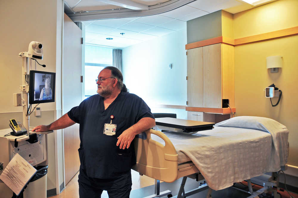 Photo by Elizabeth Earl/Peninsula Clarion Kenny Rogers, the emergency department manager at South Peninsula Hospital in Homer, Alaska, demonstrates the hospital's eICU unit on Friday, June 17, 2016. The small rural hospital will now be able to teleconference with specialists at Providence Alaska Medical Center in Anchorage to confer about patients in intensive care.