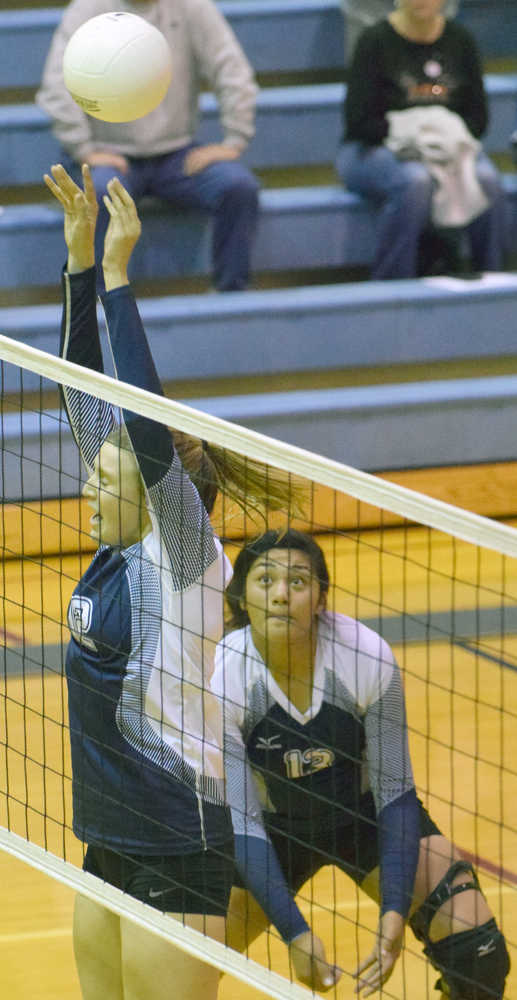 Photo by Jeff Helminiak/Peninsula Clarion Soldotna's Drewe Zeek gets a touch on the ball while Ituau Tuisaula backs her up in a match against Colony on Wednesday at Soldotna.