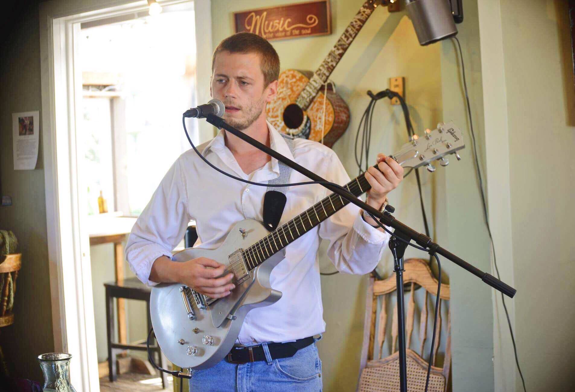 Ryan Hiller performs at Veronica’s Cafe for open mic night on Friday, Aug. 3, 2018, in Kenai, Alaska. Through the month of August, tips collected at Friday’s open mic nights from 6-8 p.m. will go to support community member, Vickie Tinker, who is fighting ovarian cancer. (Photo by Victoria Petersen/Peninsula Clarion)