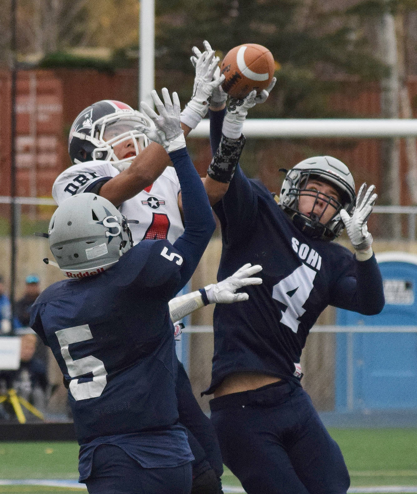 Soldotna defenders Luke Trammell (5) and Jersey Truesdell team up to cover North Pole receiver Jamie Johnson (middle), Oct. 7, 2017, at the ASAA First National Bank state football semifinals at Palmer High School. (Photo by Joey Klecka/Peninsula Clarion)