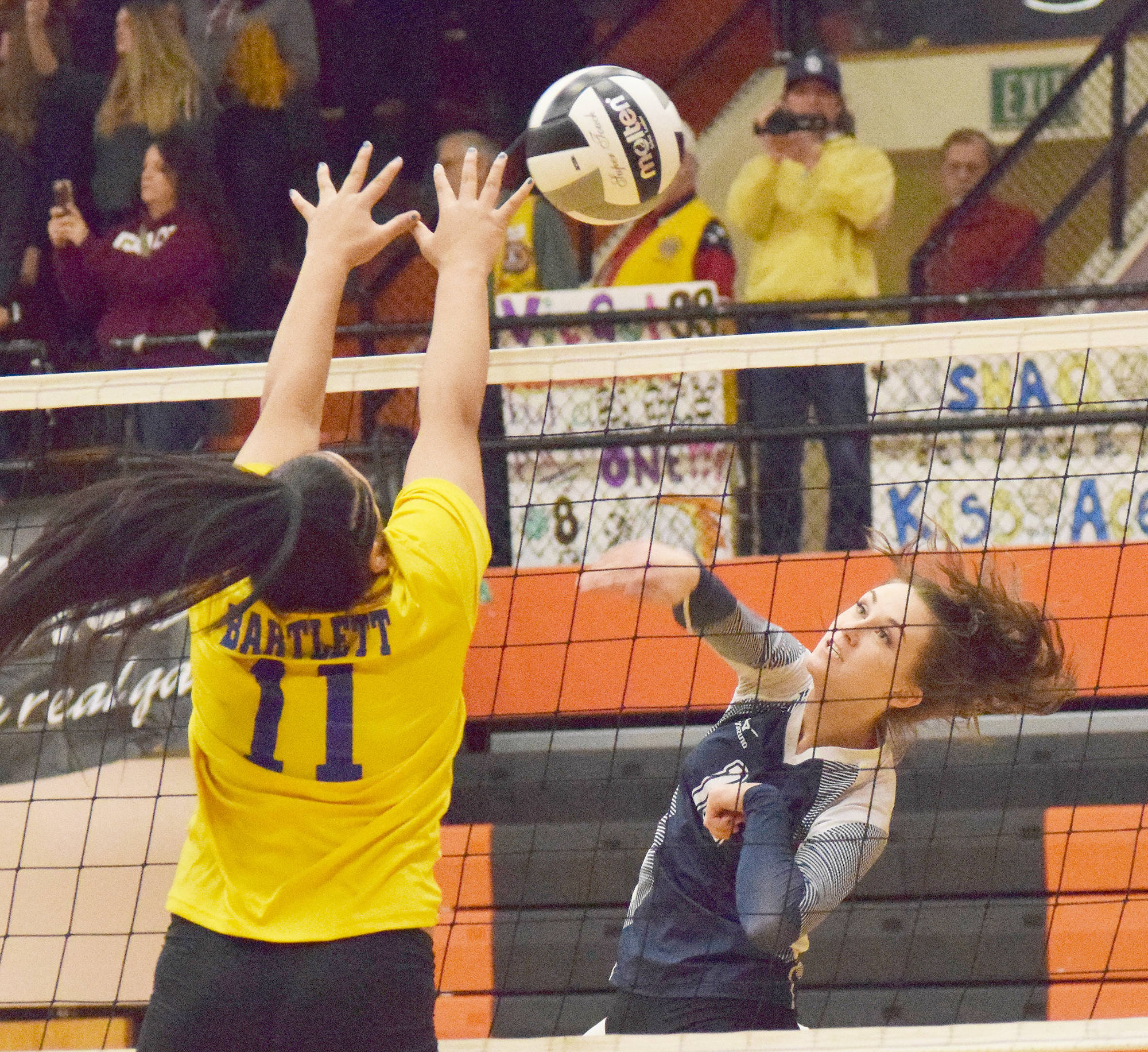 Soldotna senior Aliann Schmidt (right) sends a ball at the hands of Bartlett’s Liu Pa’ia Togaga’e last season at the Class 4A state volleyball tournament at West High School. (Photo by Joey Klecka/Peninsula Clarion)