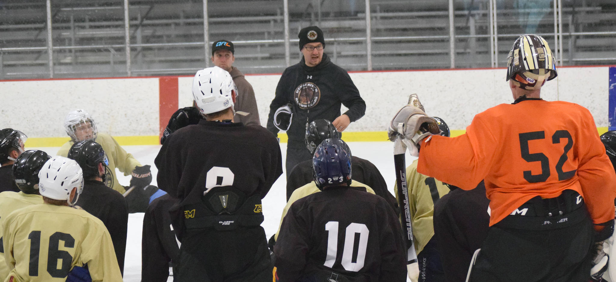 Kenai River Brown Bears head coach Josh Petrich instructs the team Monday, Aug. 27, 2018, at the Kenai Multi-Purpose Facility during the first day of training camp. (Photo by Jeff Helminiak/Peninsula Clarion)