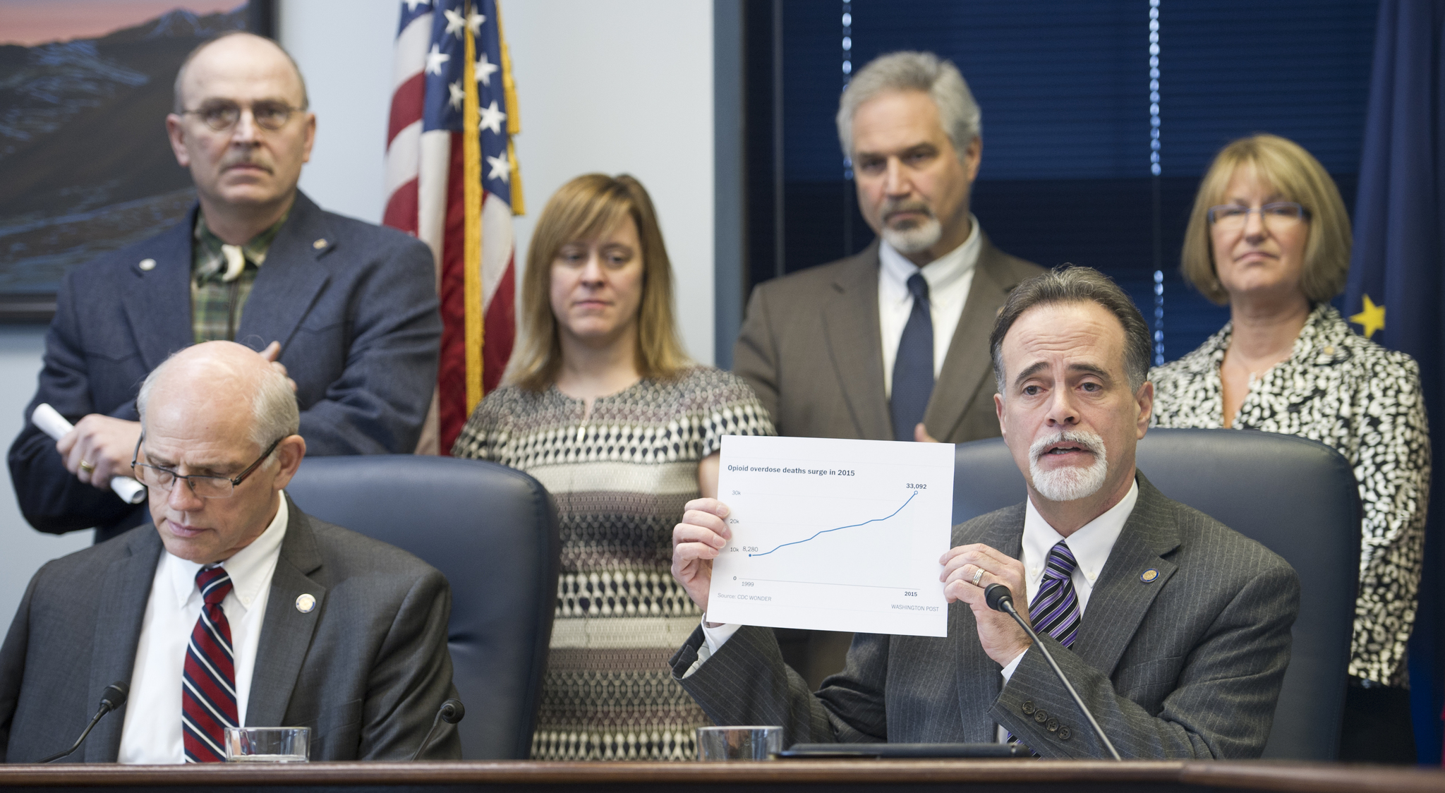 Sen. Peter Micciche, R-Soldotna, lower right, holds a graph showing the rise in opioid overdose deaths during a Senate Majority press conference on justice reform at the Capitol on Wednesday, Feb. 1, 2017. Attending also are Sen. John Coghill, R-North Pole, lower left, Sen. Chip Bishop, R-Fairbanks, upper left, Sen. Mia Costello, R-Anchorage, Senate President Pete Kelly, R-Fairbanks, and Sen. Anna MacKinnon, R-Eagle River, upper right. (Michael Penn/Juneau Empire)
