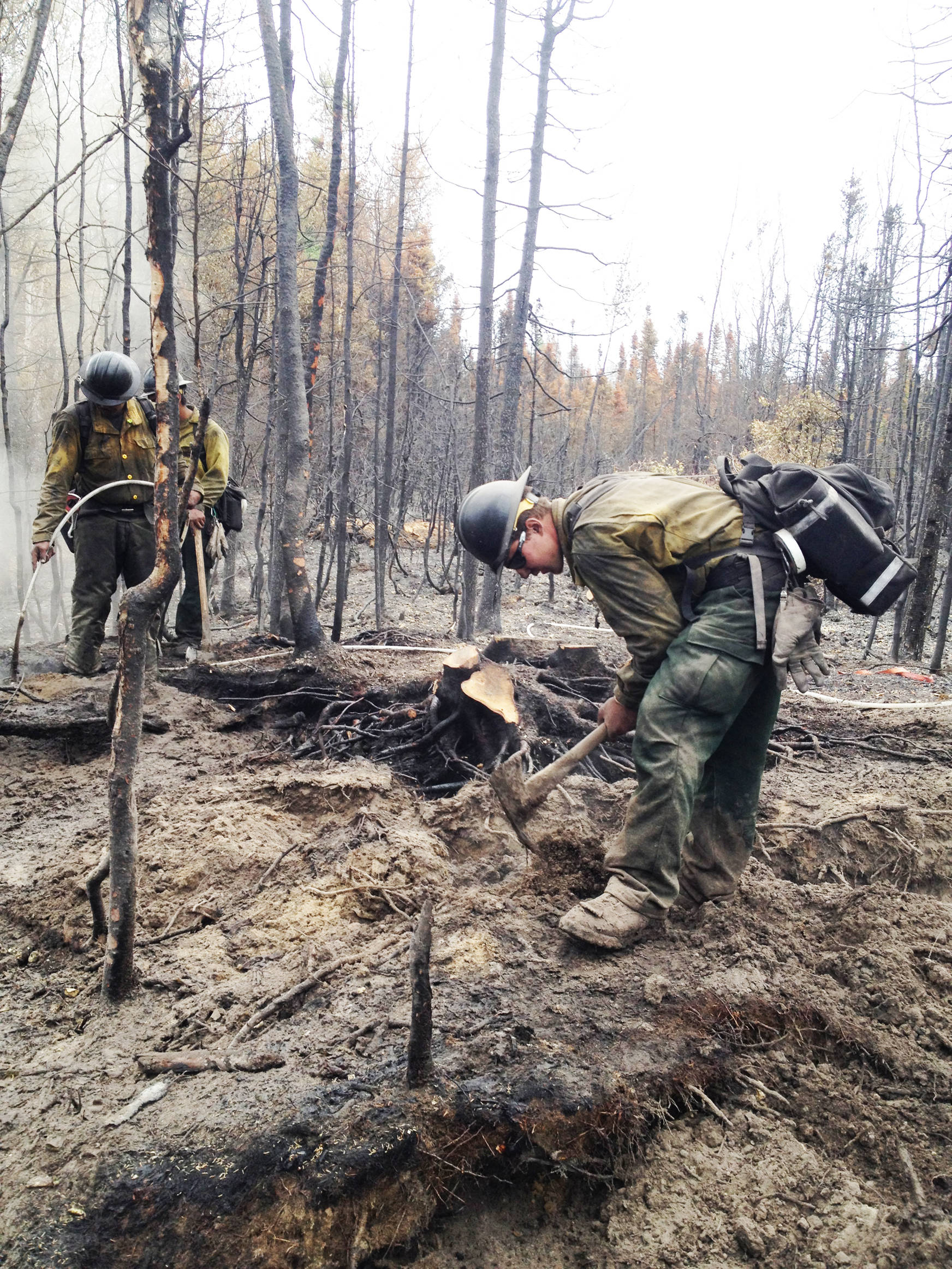 Members of the Yukon Fire Crew, highly trained hotshot wildland firefighters, perform mop up work on the Kenai Peninsula in 2015. The Type 2 Hand Crew is based on the peninsula for a large part of the year in trailers parked on land leased to the nonprofit Chugachmiut, Inc. by the Kenai Peninsula Borough. Chugachmiut is seeking a grant that would allow the organization to build a permanent camp on land it bought in 2011. (Photo courtesy Nathan Lojewski)