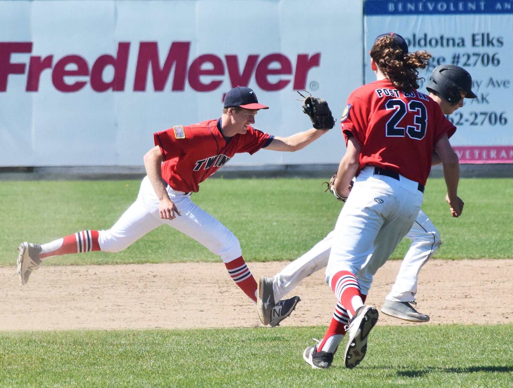 Post 20 Twins shortstop Cody Quelland runs down a West baserunner Thursday at the Bill Miller Wood Bat Tournament at Coral Seymour Memorial Ballpark in Kenai. (Photo by Joey Klecka/Peninsula Clarion)