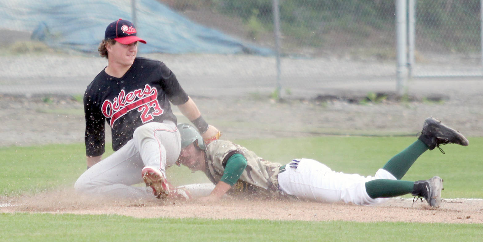 Mat-Su Miners infielder Austin Dennis steals third base, sliding into the bag behind Peninsula third baseman Nathan Webb during a 2-1 win over the Oilers on Thursday afternoon at Hermon Brothers Field in Palmer. With the win, the Miners swept the best-of-three first-round series and move into the Alaska Baseball League Top of the World Series, which starts Friday at 6 p.m. at Hermon Brothers Field. (Photo by Jeremiah Bartz/Frontiersman)