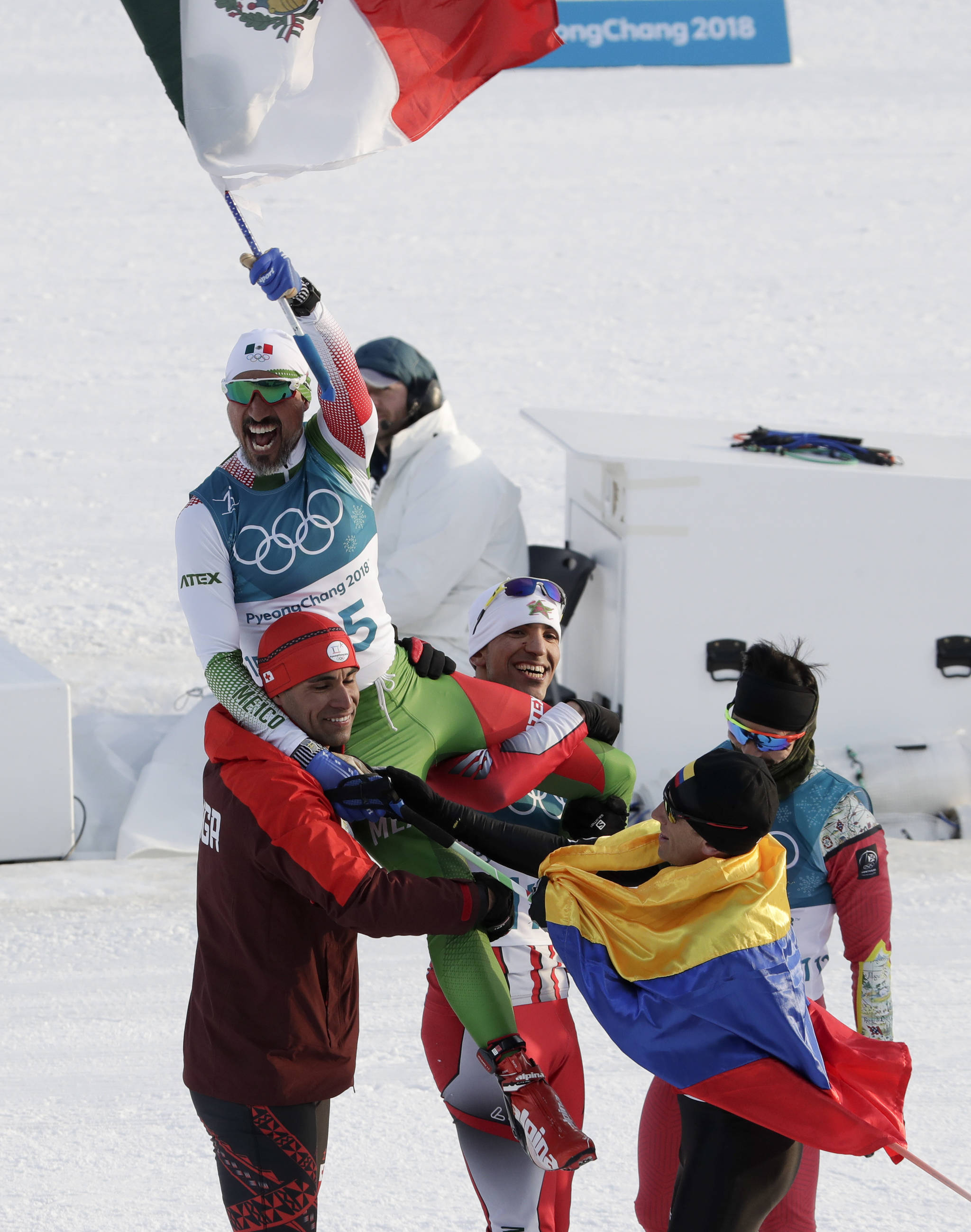 German Madrazo, of Mexico, holds up his countries flag after finishing last in the men’s 15km freestyle cross-country skiing competition at the 2018 Winter Olympics in Pyeongchang, South Korea Feb. 16. (AP Photo/Dmitri Lovetsky)