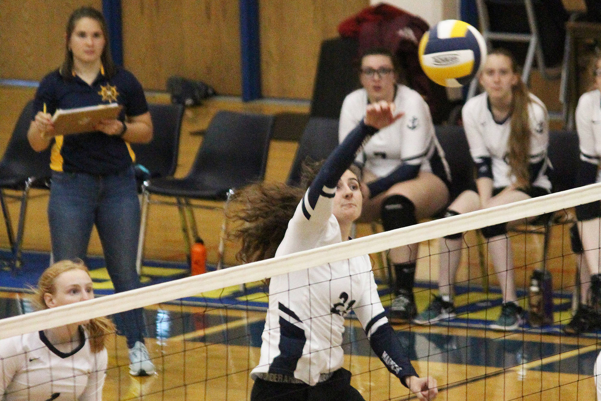 Homer’s Marina Carroll spikes the ball over the net during a game against Kenai Central High School on Thursday, Sept. 13, 2018 at Homer High School in Homer, Alaska. The Mariners beat the Kardinals three games to one in the Southcentral Conference match-up. (Photo by Megan Pacer/Homer News)