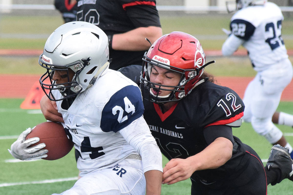 Kenai defender Tyrone McEnerney tackles Eagle River’s Kobe Sherman (24) Saturday at Ed Hollier Field in Kenai. (Photo by Joey Klecka/Peninsula Clarion)