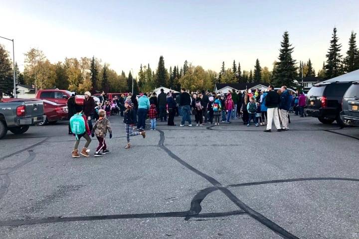 Students, parents, teachers and district faculty gather in the parking lot of a Soldotna church early in the morning on Tuesday, Sept. 25, 2018, in Soldotna, Alaska. (Photo by Victoria Petersen/Peninsula Clarion)