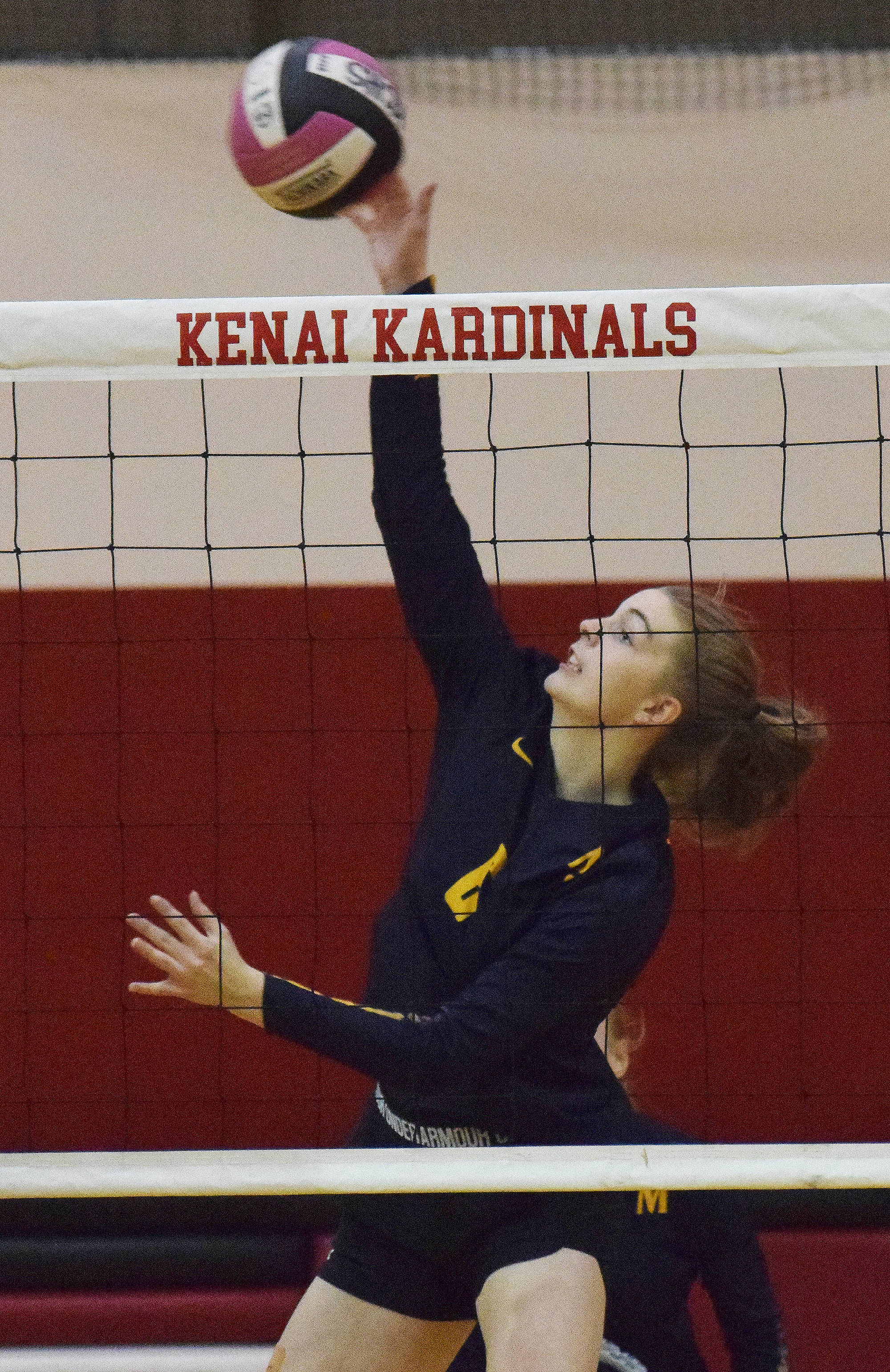 Homer senior Kelsea Scott (4) unleashes a hit Friday night at Kenai Central High School. (Photo by Joey Klecka/Peninsula Clarion)