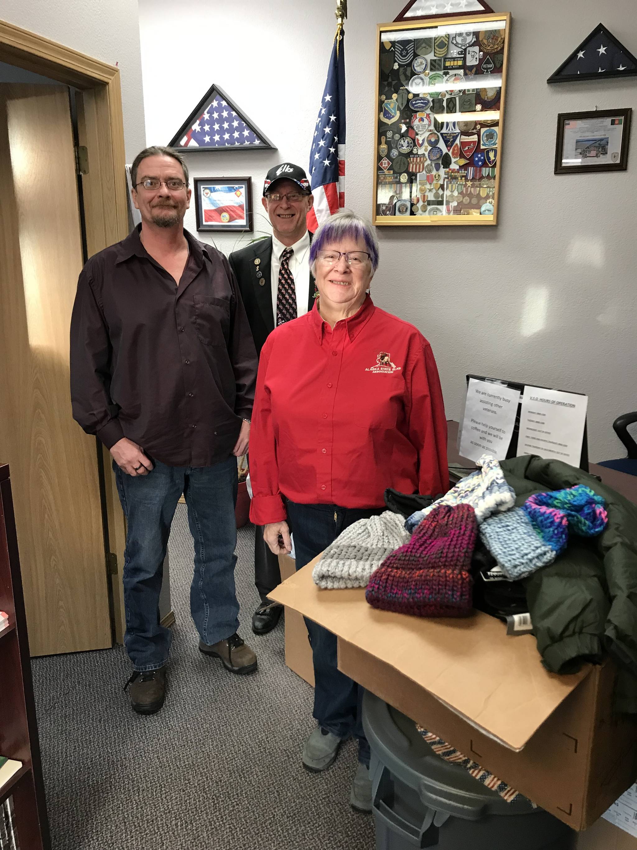 Kenai Elks Lodge Exalted Ruler Ken Cole and Kenai Elks Lodge Member Marti Slater present donated winter items to the Ronald Engebretson of the Kenai Vet Center on Wednesday in Kenai. (Courtesy photo)