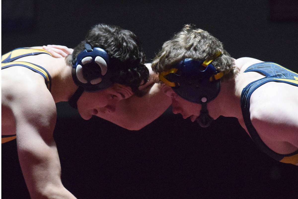 Homer teammates Josh Bradshaw (left) and Mose Hayes square off in the 152-pound championship Saturday at the Kachemak Conference wrestling tournament at Grace Christian High School in Anchorage. (Photo by Joey Klecka/Peninsula Clarion)