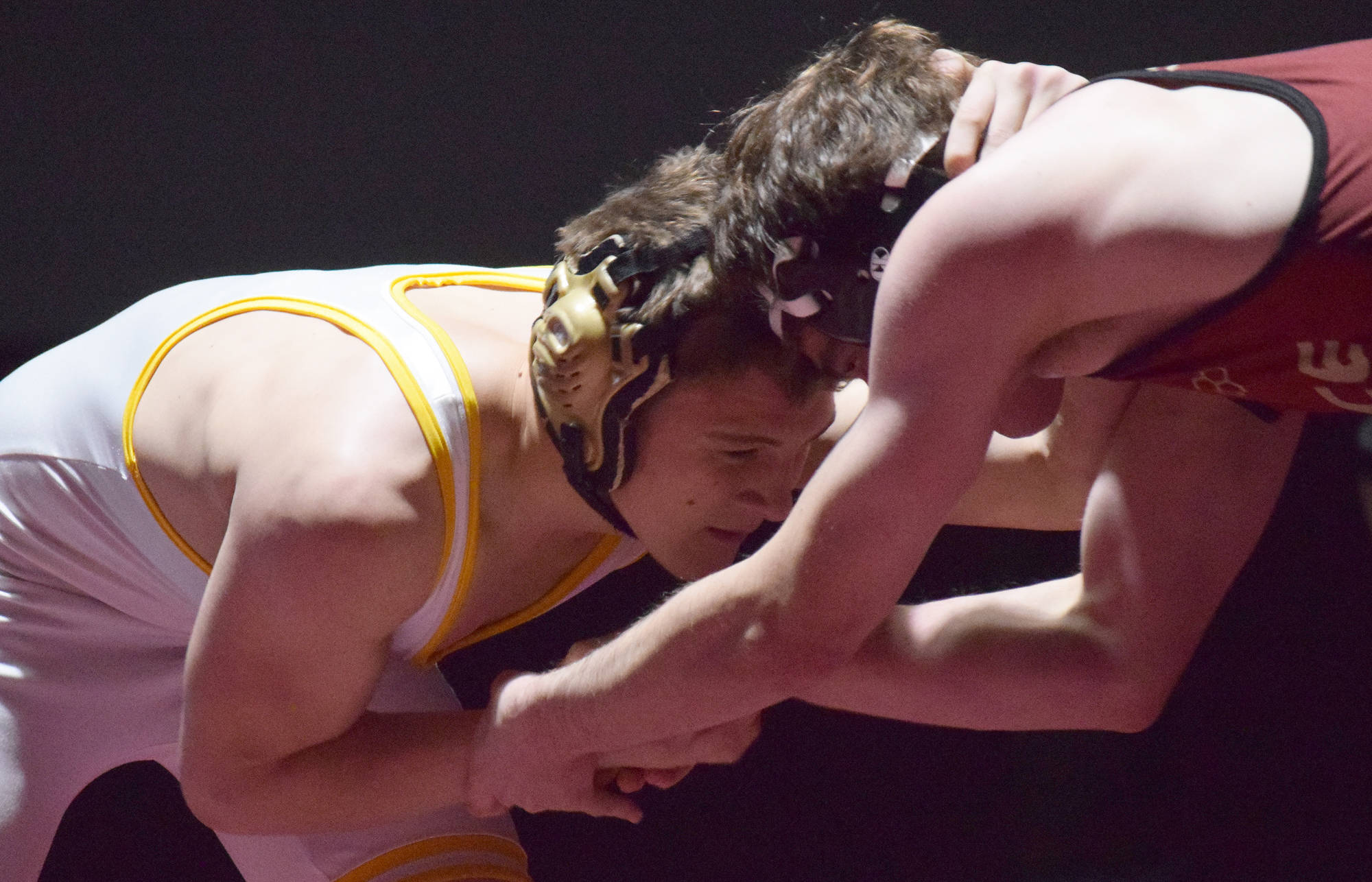 Voznesenka’s Anthony Kalugin locks horns with Eliot Merriner of Grace Saturday in the 171-pound championship at the Kachemak Conference wrestling tournament at Grace Christian High School in Anchorage. (Photo by Joey Klecka/Peninsula Clarion)