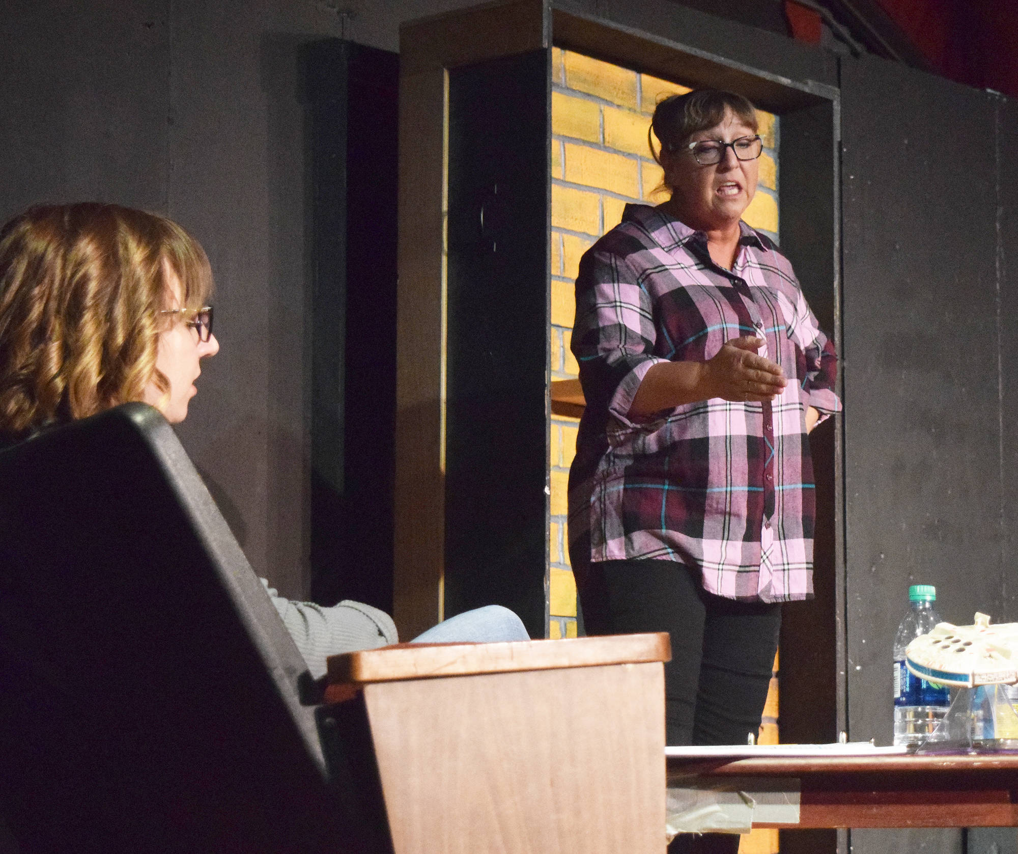 Donna Shirnberg (right) rehearses Tuesday with Hannah Tauriainen in preparation for “Inspecting Carol” Tuesday at the Triumvirate North Theatre in Kenai. (Photo by Joey Klecka/Peninsula Clarion)