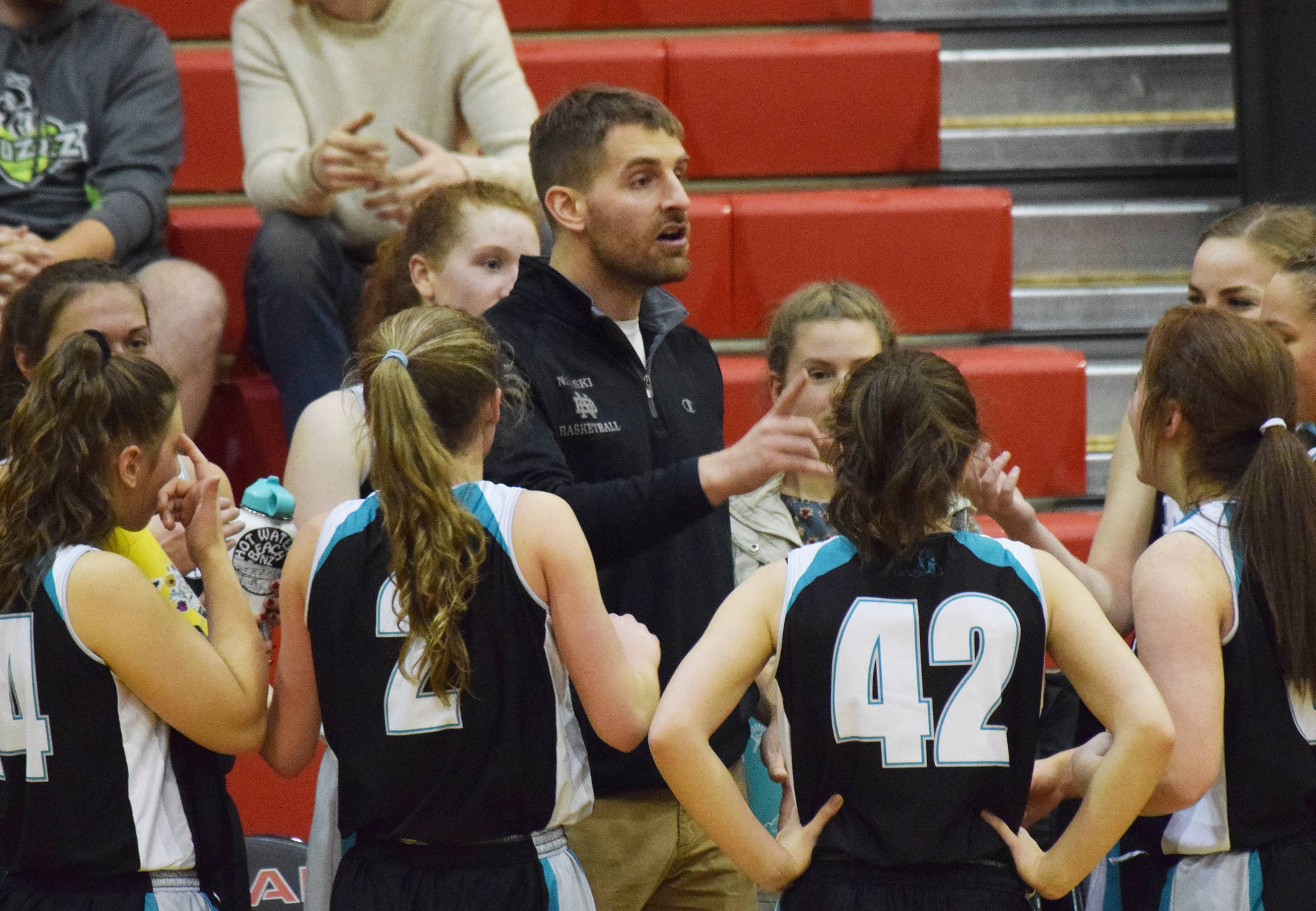 Nikiski girls head coach Rustin Hitchcock talks to his team Thursday against Kotzebue at the Craig Jung Kenai River Challenge at Kenai Central High School. (Photo by Joey Klecka/Peninsula Clarion)