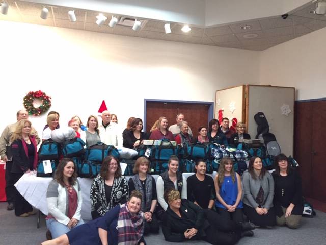 Members of the Kenai Peninsula Association of Realtors are photographed last week in Kenai, Alaska. The Realtors donated 30 filled duffel bags to children in the Kenai Peninsula Borough School District’s Students in Transition Program. (Photo courtesy of Kelly Martin)