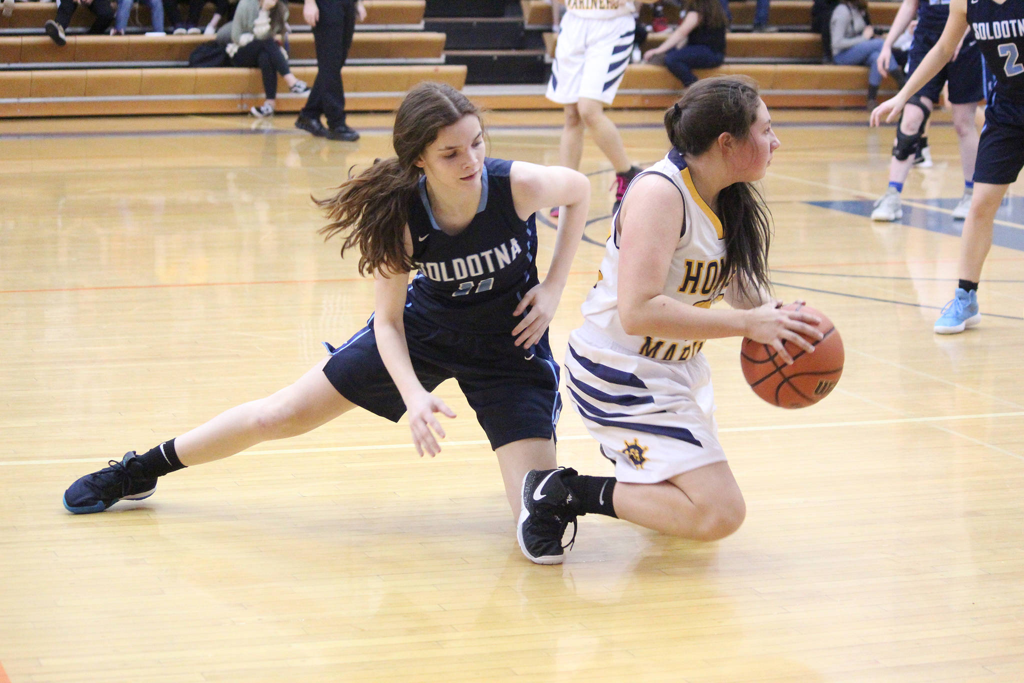 Homer’s Hannah Hatfield wins a loose ball from Soldotna High School’s Morgan Bouschor during a Tuesday, Jan. 15, 2019 game in Homer, Alaska. (Photo by Megan Pacer/Homer News)