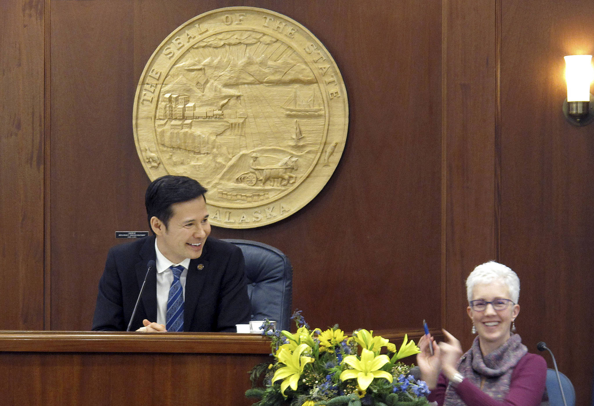 Democratic Alaska state Rep. Neal Foster, left, smiles after being elected temporary speaker of the House, Thursday, in Juneau. The House has yet to organize a majority and elect a permanent speaker. (AP Photo/Becky Bohrer)