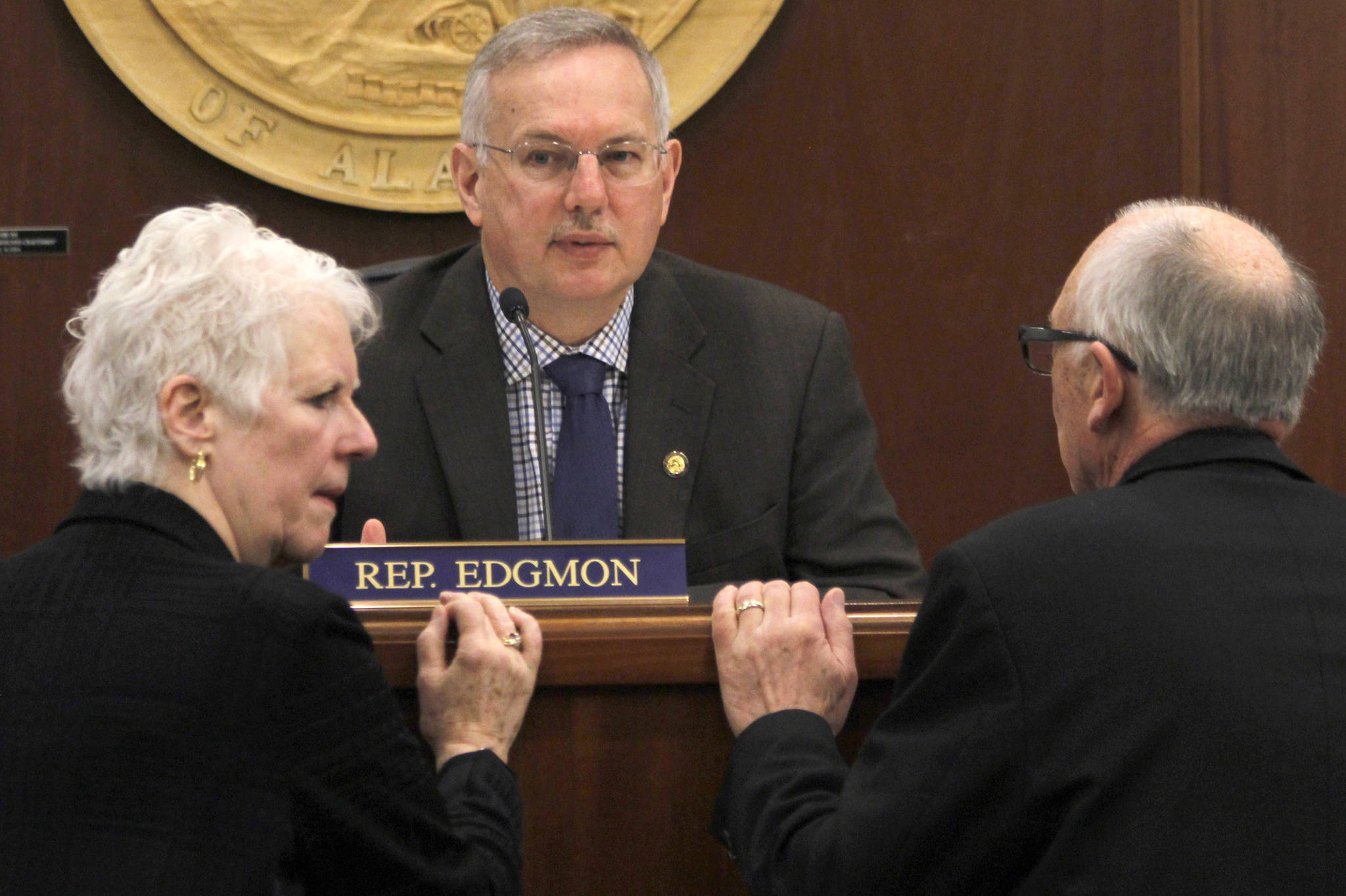 Speaker of the House Bryce Edgmon, center, speaks with Rep. Louise Stutes, R-Kodiak and Rep. Steve Thompson, R-Fairbanks, during a House floor session on Wednesday, April 10, 2019. (Alex McCarthy | Juneau Empire)