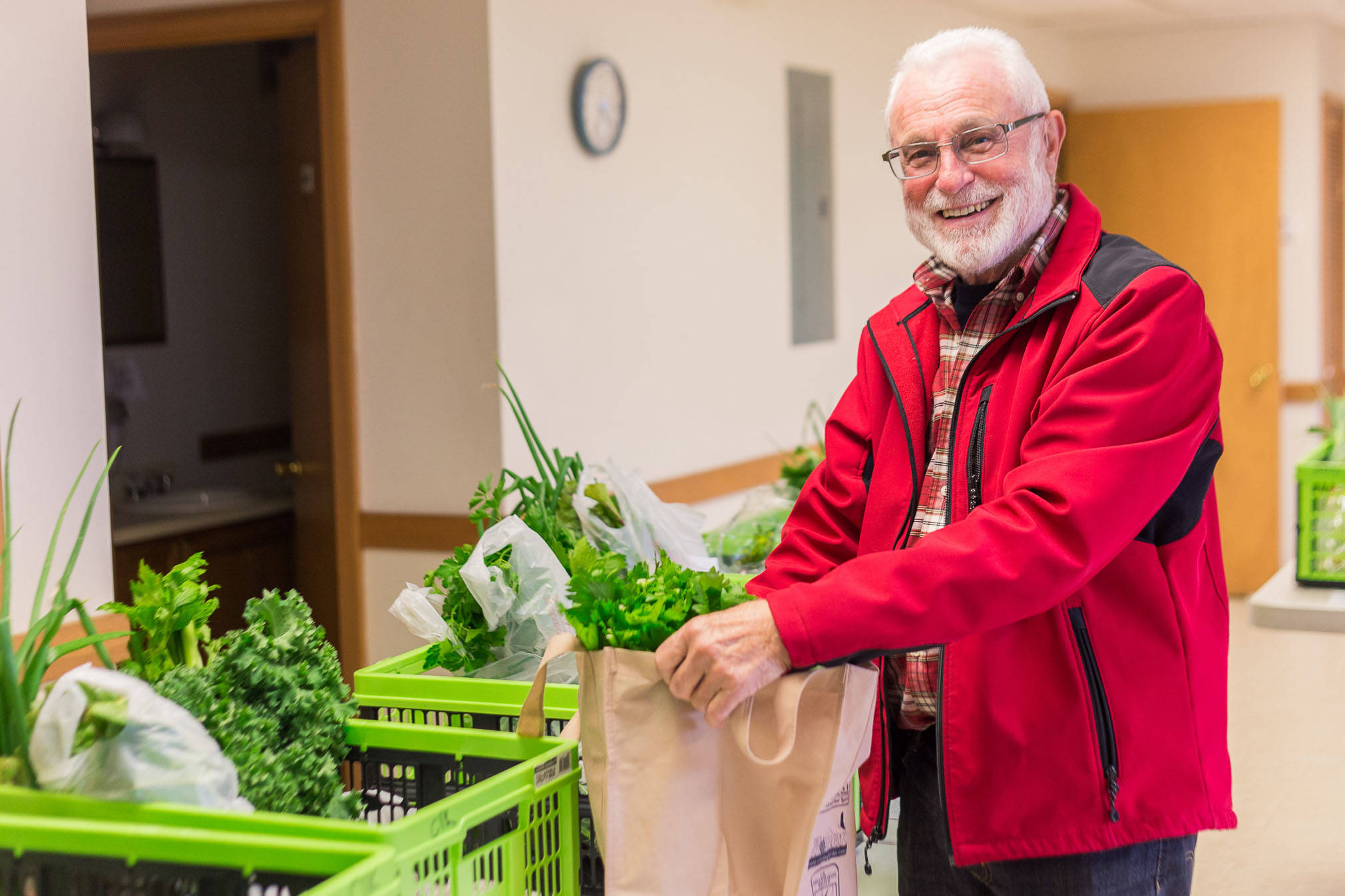 Alaska Food Hub customer Roger Clyne picks up his order at one of the Food Hub’s designated locations in this undated photo. (Photo courtesy of Robbi Mixon/Alaska Food Hub)