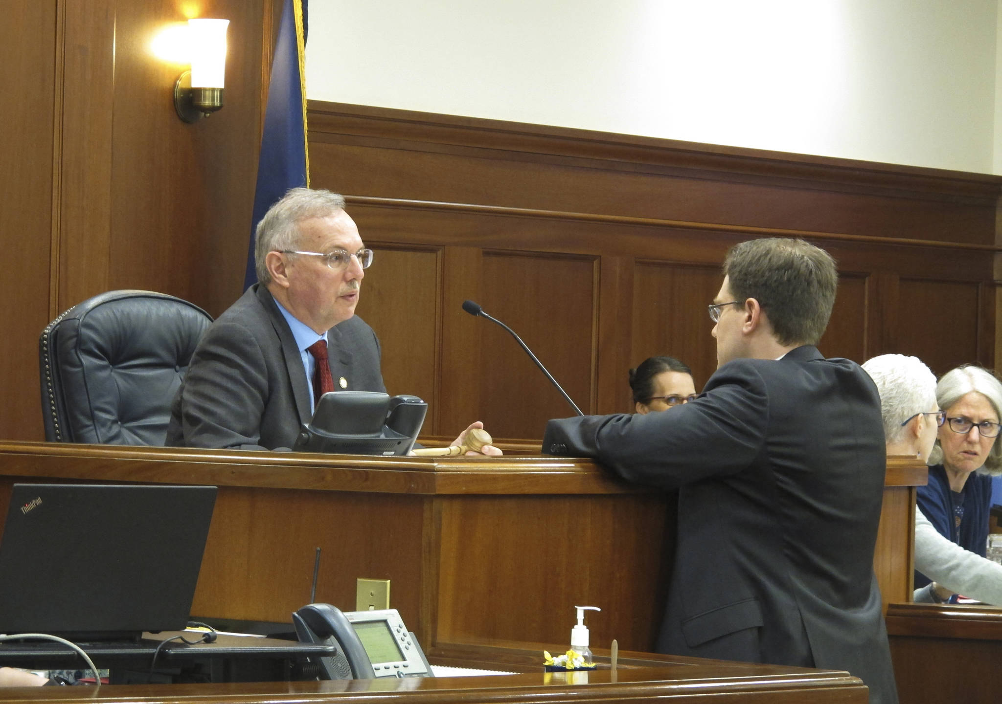 Alaska House Speaker Bryce Edgmon, left, speaks to House Minority Leader Lance Pruitt before the start of the House floor session on Wednesday, May 15, 2019, Juneau, Alaska. Wednesday marked a constitutional deadline for the end of the regular session. (AP Photo/Becky Bohrer)