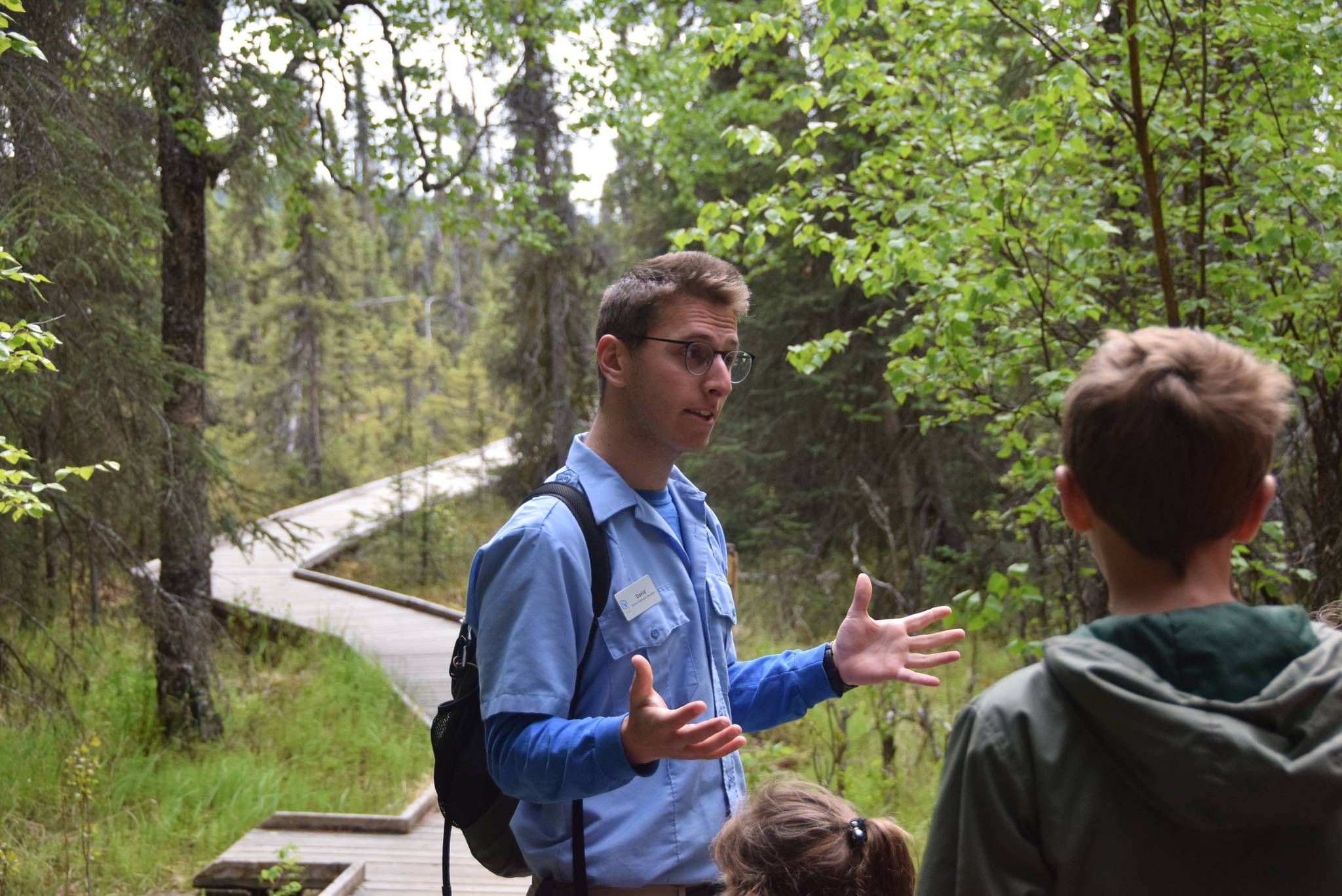 Environmental education intern David Fink answers questions from the hikers during a guided hike on Centennial Trail in the Kenai National Wildlife Refuge on June 1, 2019. (Photo by Brian Mazurek/Peninsula Clarion)