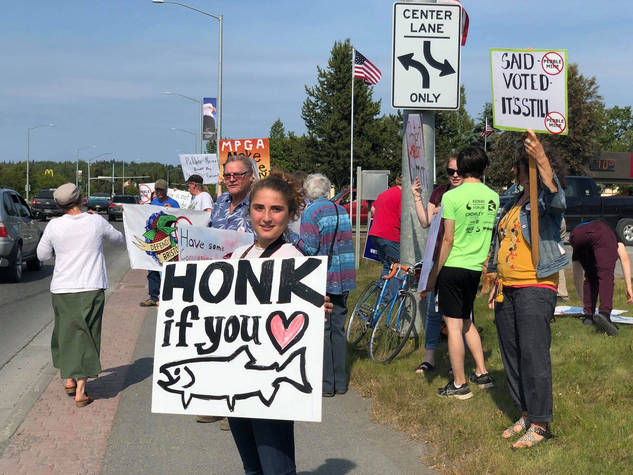 Residents line the Sterling Highway, in front of Sen. Lisa Murkowski’s office to oppose Pebble mine on Wednesday, June 26, 2019, in Soldotna, Alaska. (Photo by Victoria Petersen/Peninsula Clarion)