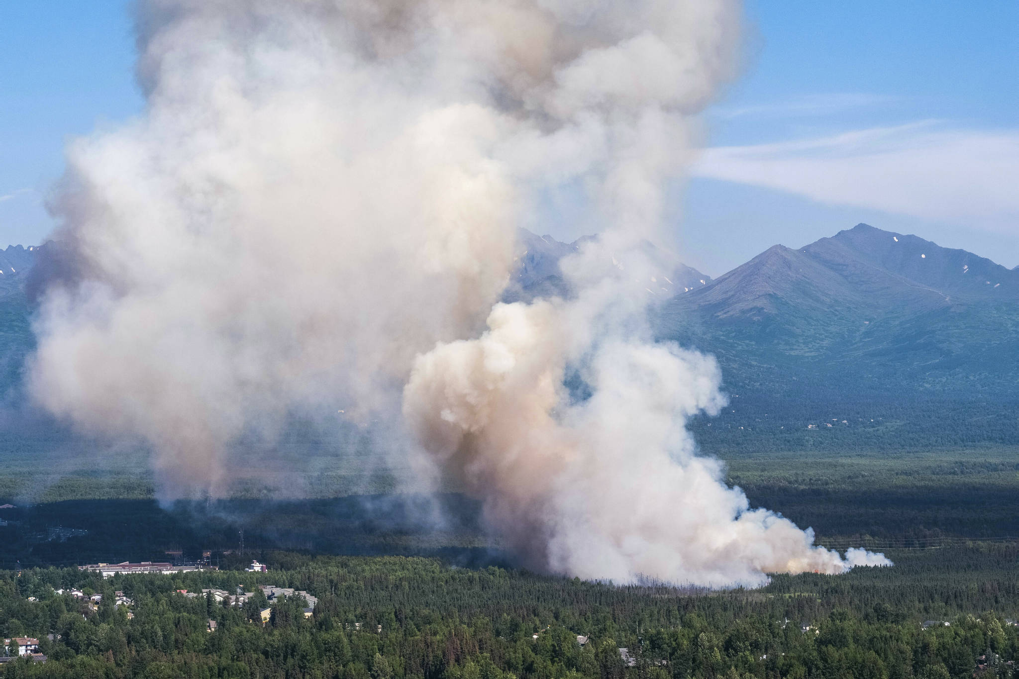 A brush fire burns in South Anchorage, Alaska, Tuesday, July 2, 2019. (Loren Holmes/Anchorage Daily News via AP)