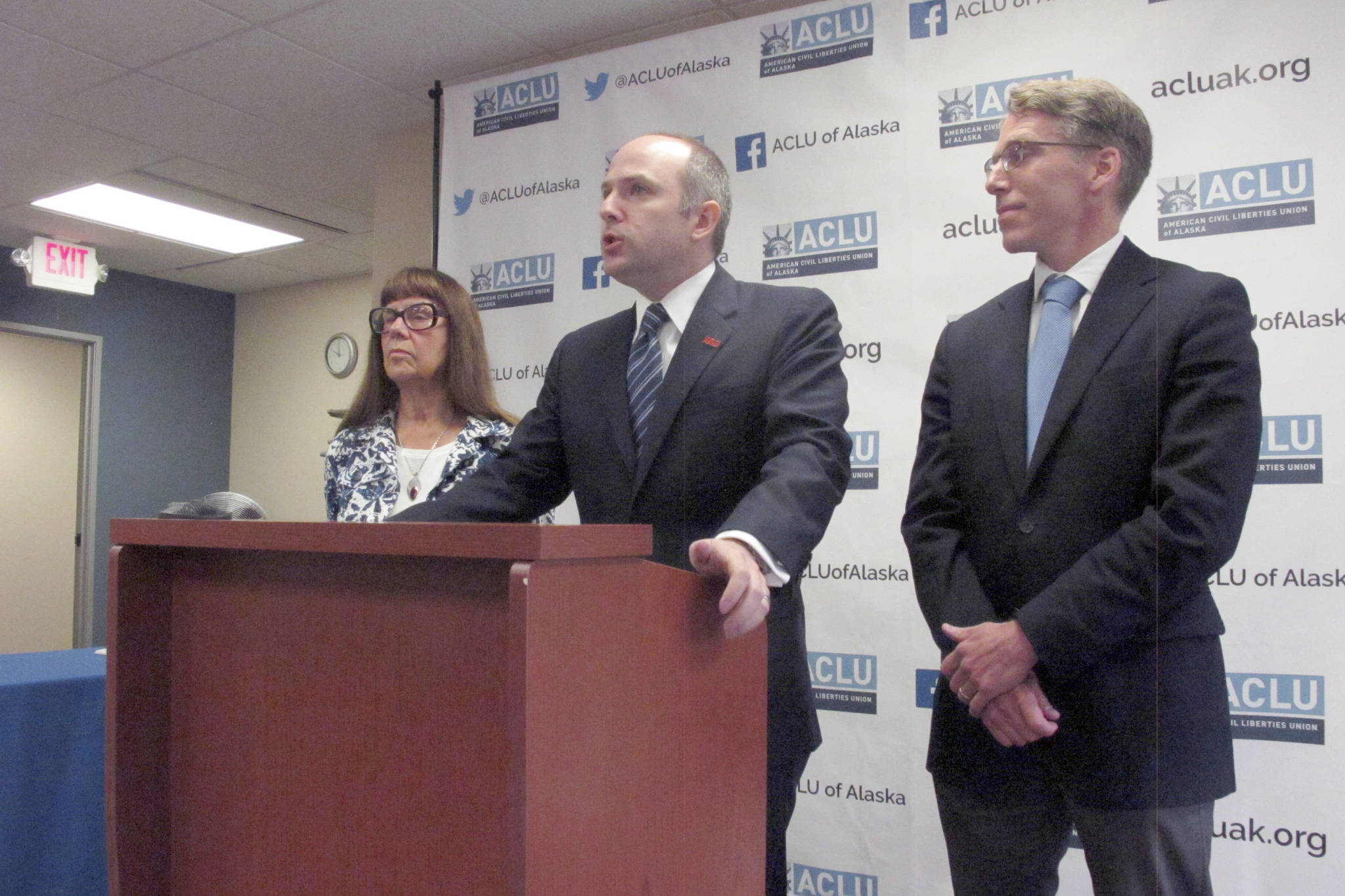 Joshua Decker, center, director of the ACLU of Alaska, speaks at a press conference with Bonnie Jack, left, and John Kauffman on Wednesday, in Anchorage. (AP Photo/Dan Joling)