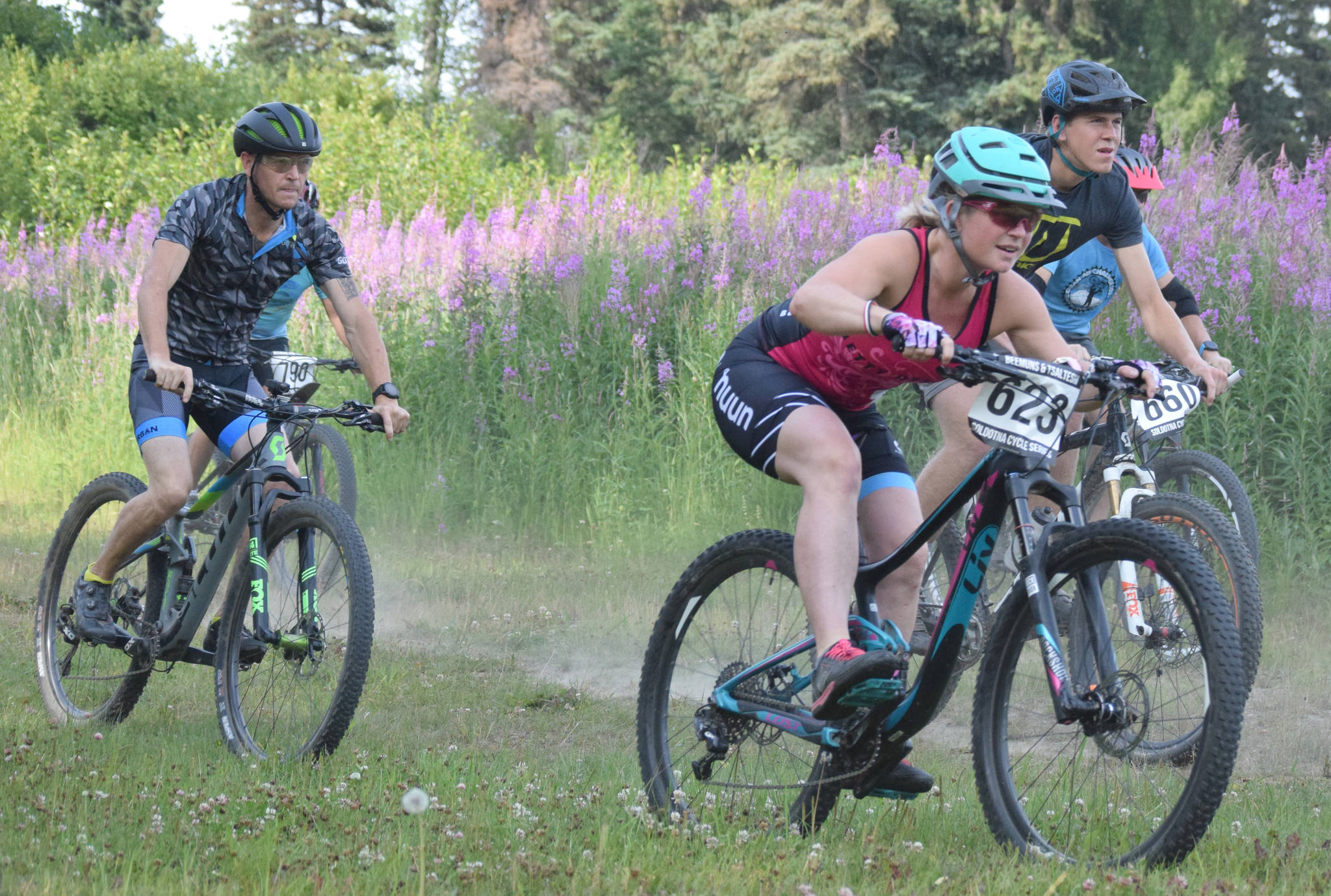 Morgan Aldridge leads riders down a hill at the start of Week 3 of the Soldotna Cycle Series on Thursday, July 18, 2019, at Tsalteshi Trails. (Photo by Jeff Helminiak/Peninsula Clarion)