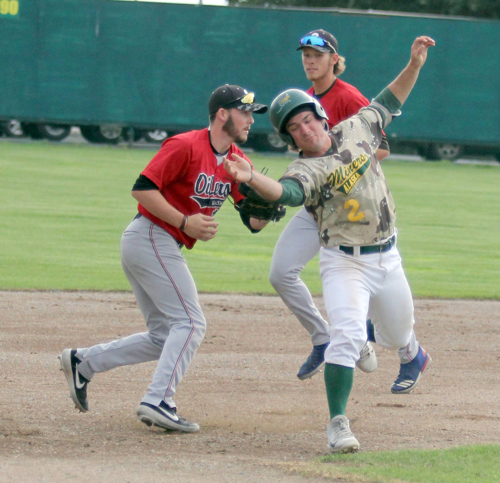 Mat-Su’s Erik Webb tries to avoid the tag of Peninsula Oilers infielder Victor Carlino during a 5-0 win over the Oilers Friday, July 19, 2019, at Hermon Brothers Field In Palmer. Webb was caught in a rundown between second and third. (Photo by Jeremiah Bartz/Frontiersman)