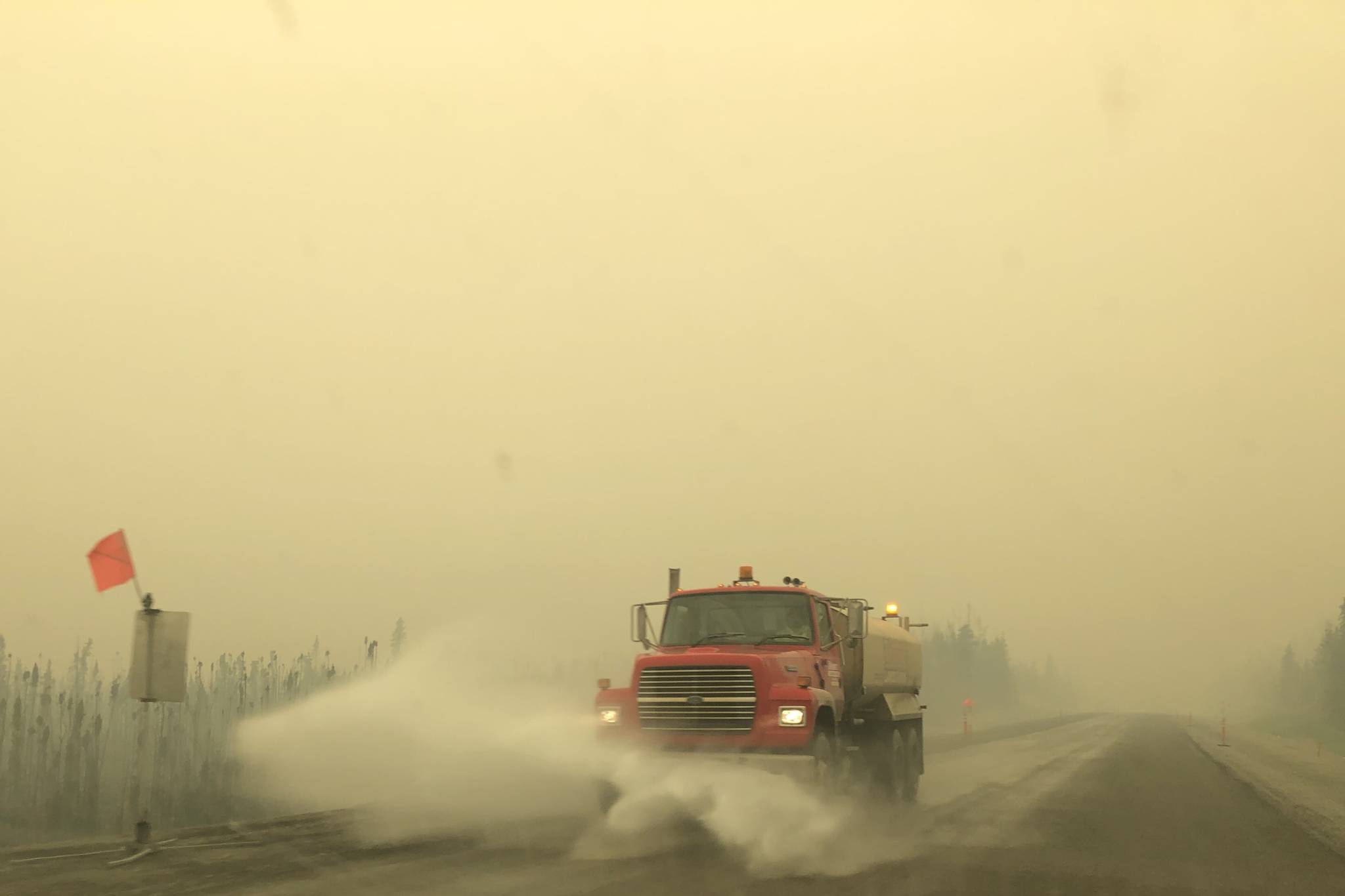 A truck on the Sterling Highway plows through ash produced by the Swan Lake Fire on Aug. 20, 2019. (Photo by Victoria Petersen/Peninsula Clarion)