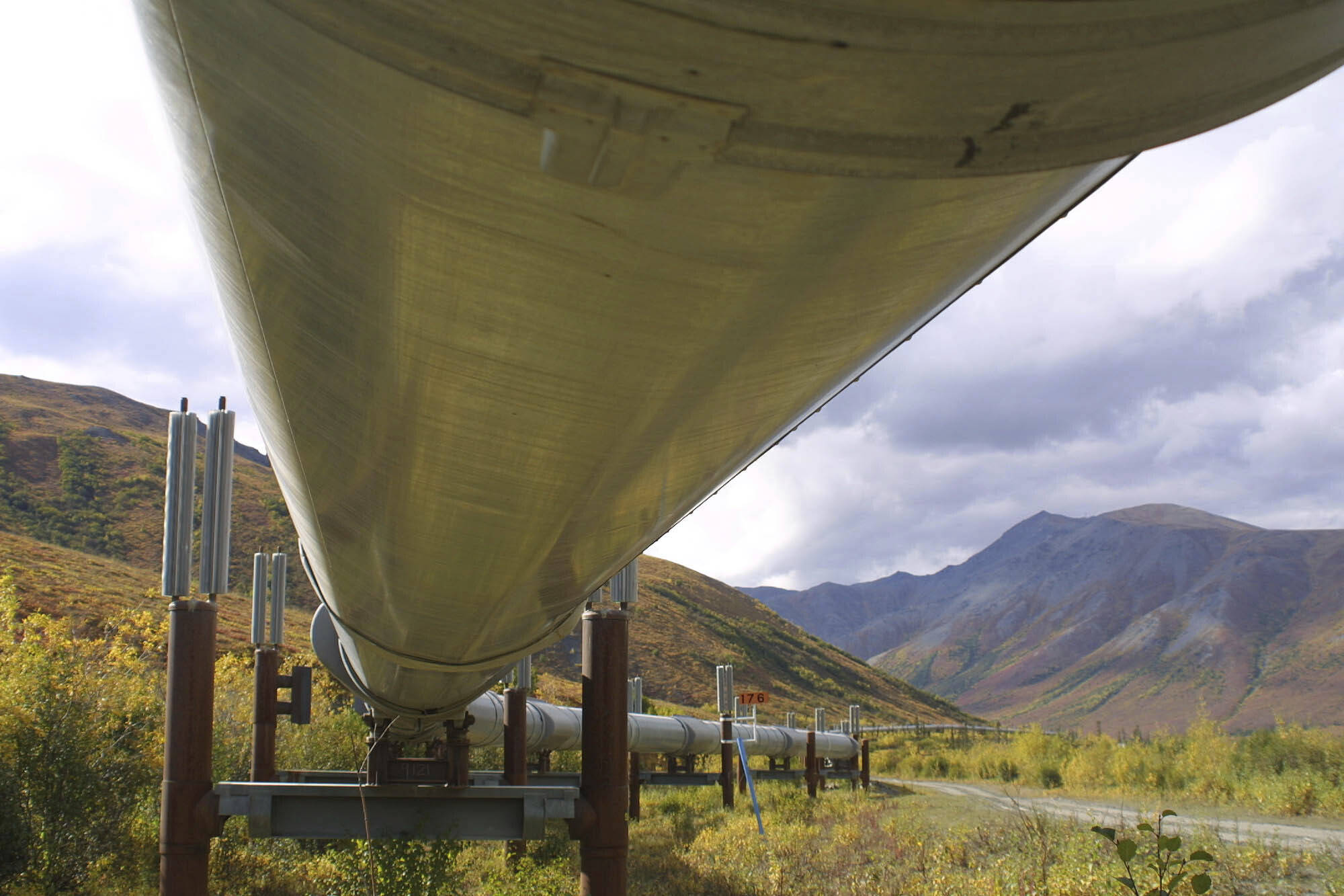 In this undated file photo showing the 800-mile Trans-Alaska pipeline that feeds 950,000 barrels of oil a day to the West Coast snakes it way across the tundra north of Fairbanks, Alaska. BP, a major player on Alaska’s North Slope for decades, is selling all of its assets in the state, the company announced Tuesday, Aug. 27, 2019. Hilcorp Alaska is purchasing BP interests in both the Prudhoe Bay oil field and the trans-Alaska pipeline for $5.6 billion, BP announced in a release. (AP Photo/Al Grillo, File)