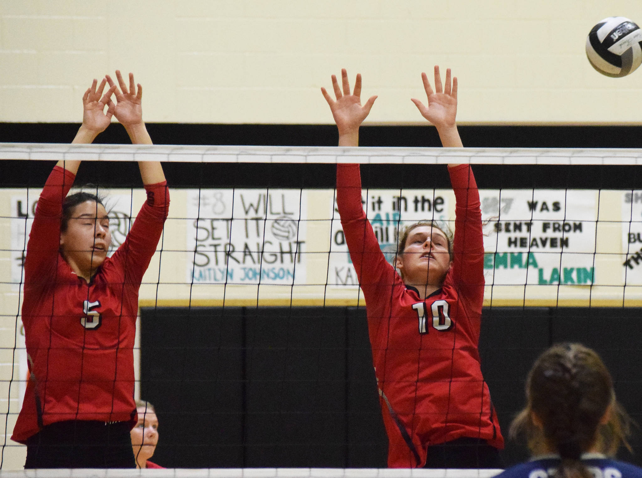 Kenai Central’s Chelsea Plagge (left) and Abby Every set up a block Saturday, Sept. 8, 2019, against Soldotna in the Shayna Pritchard Memorial Volleyball Tournament final at Nikiski High School. (Photo by Joey Klecka/Peninsula Clarion)