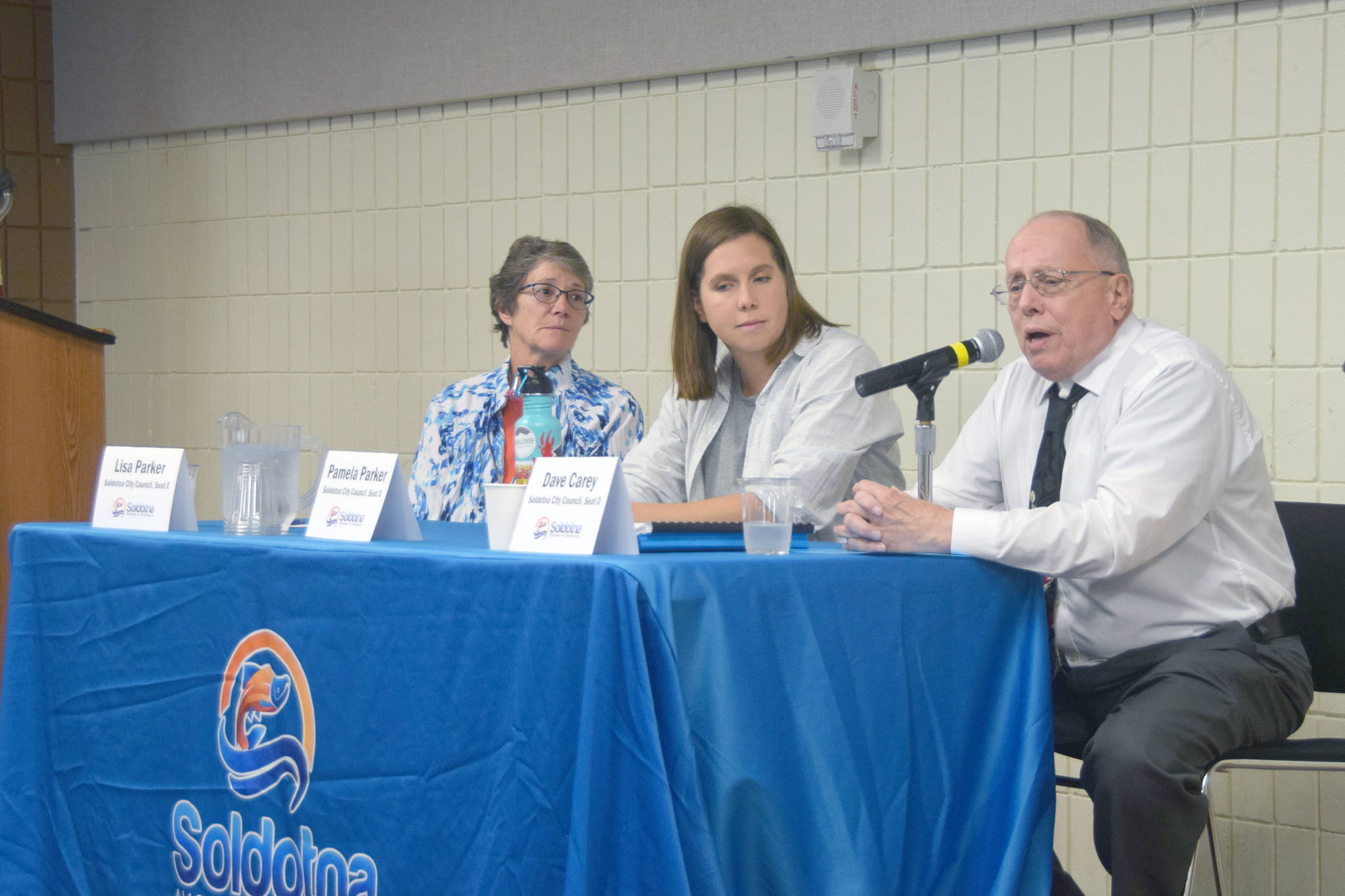 Brian Mazurek / Peninsula Clarion                                 Soldotna City Council candidates Lisa Parker, Pamela Parker and Dave Carey speak to members of the Soldotna Chamber of Commerce at the Soldotna Sports Complex on Sept. 11.