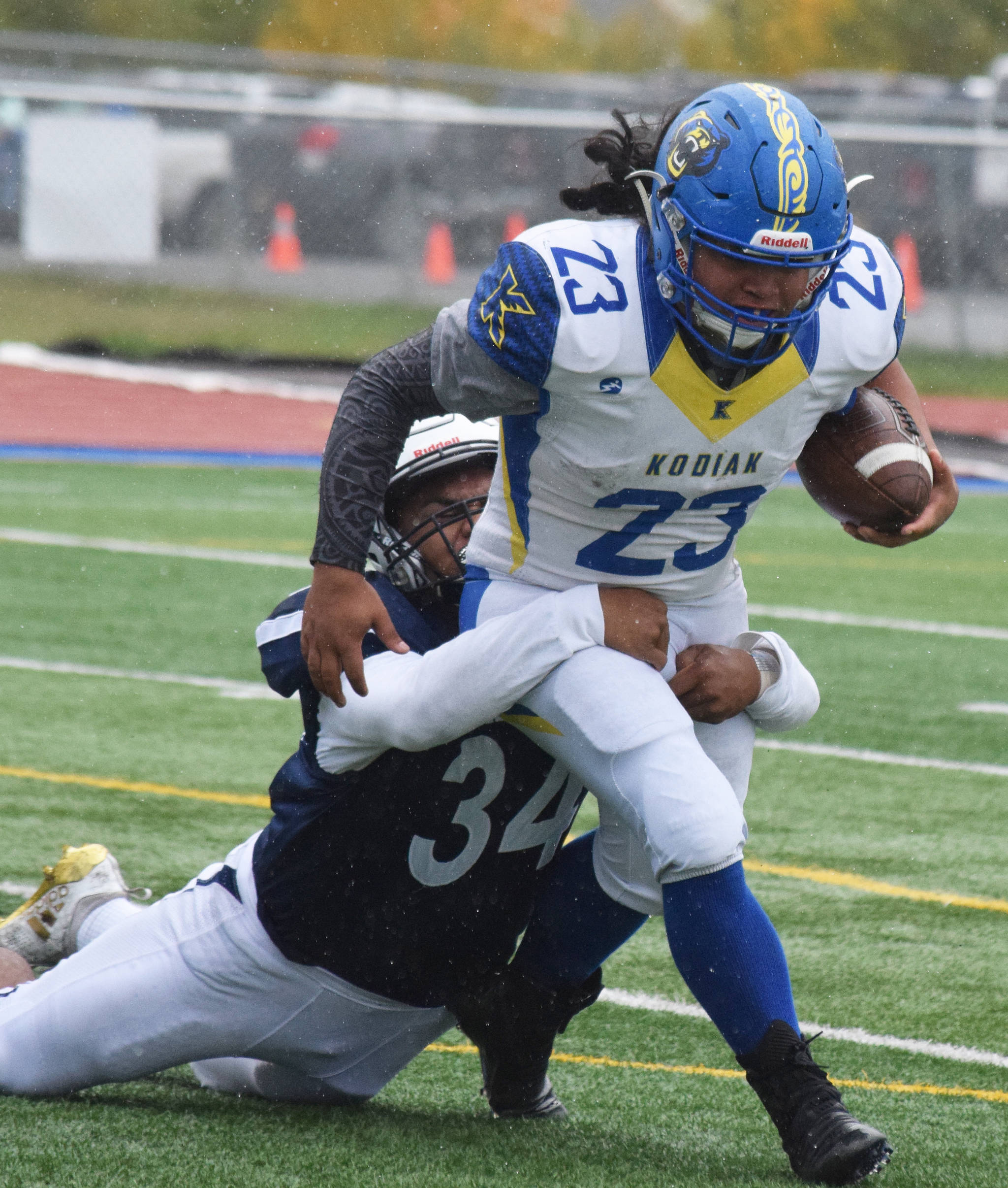 Kodiak’s Josue Martinez attempts to shed a tackle from Soldotna’s Aaron Faletoi, Saturday, Sept. 21, 2019, at Justin Maile Field in Soldotna, Alaska. (Photo by Joey Klecka/Peninsula Clarion)