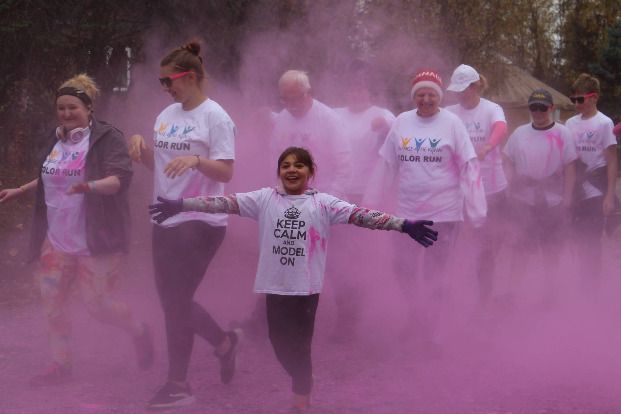 Participants in the 2019 Stomp Out Stigma Color Run make their way through a haze of pink chalk at Soldotna Creek Park on Saturday, Sept. 28, 2019. (Photo by Brian Mazurek/Peninsula Clarion)