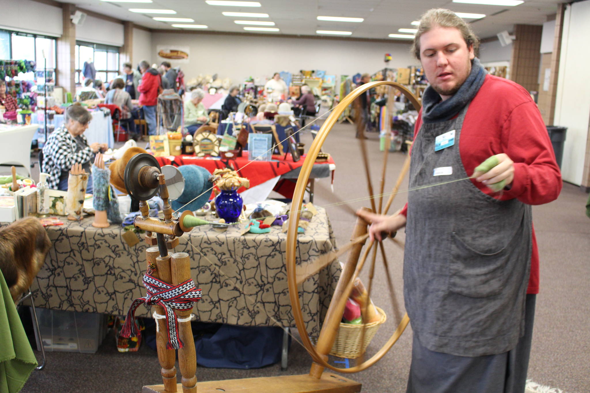 Brian Mazurek / Peninsula Clarion                                Cole Harmon shows off his great wheel — also known as a muckle wheel — during the Fireweed FiberFest at the Soldotna Regional Sports Complex on Saturday, Sept. 28, 2019. Harmon spins with qiviut, which is the inner wool of the musk ox and is harvested by Alaska Native elders in Nome. Harmon discovered recently that his wheel was built in the 1750s out of salvaged shipwreck wood by Quakers on the east coast. The wood itself is about 900 years old and was originally harvested in Scotland.