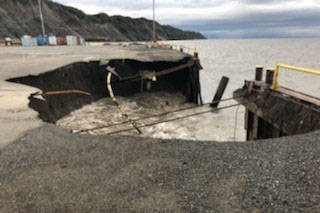 Heavy seas caused an Offshore System Kenai (OSK) earth and fill dock, with fuel lines, to collapse, Oct. 2, 2019, resulting in the discharge of approximately 300 gallons of oil. Inspectors from Coast Guard Marine Safety Detachment Homer responded to the incident and are coordinating with the responsible party and state authorities to mitigate further pollution. The dock continues to erode, but all remaining hazardous materials have been removed. (U.S. Coast Guard courtesy photo)