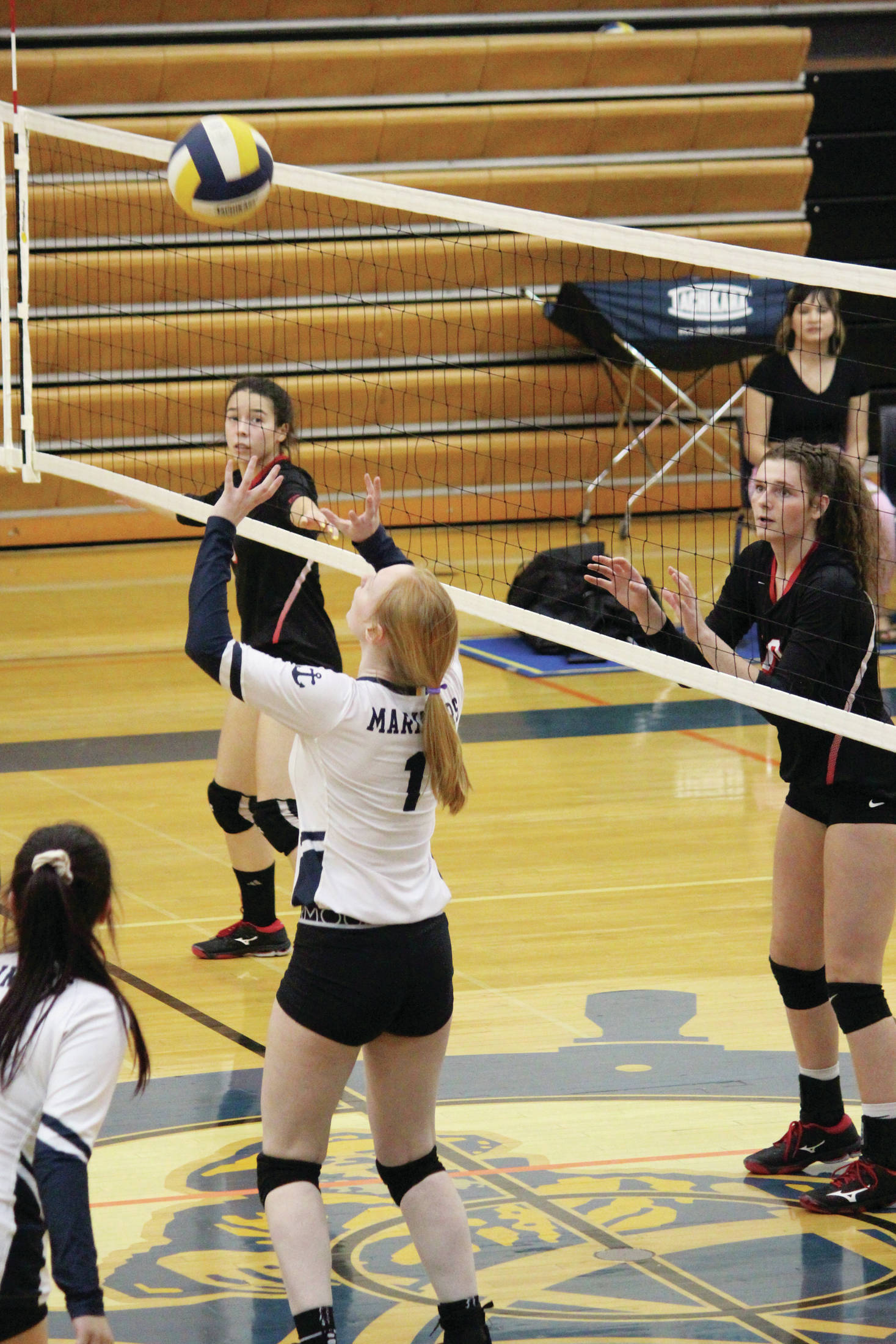 Homer’s Kelli Bishop sets the ball to a teammate during a Tuesday, Oct. 29, 2019 volleyball game against Kenai Central High School at the Alice Witte Gymnasium in Homer, Alaska. (Photo by Megan Pacer/Homer News)