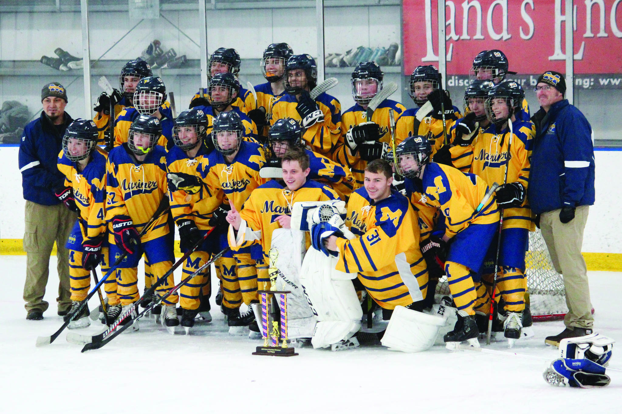 The Homer hockey team celebrates winning the End of the Road Shootout Tournament on Saturday, Nov. 16, 2019 at Kevin Bell Arena in Homer, Alaska. The Mariners won all three of their games against East Anchorage, Soldotna and Houston to take the tournament title. (Photo by Megan Pacer/Homer News)